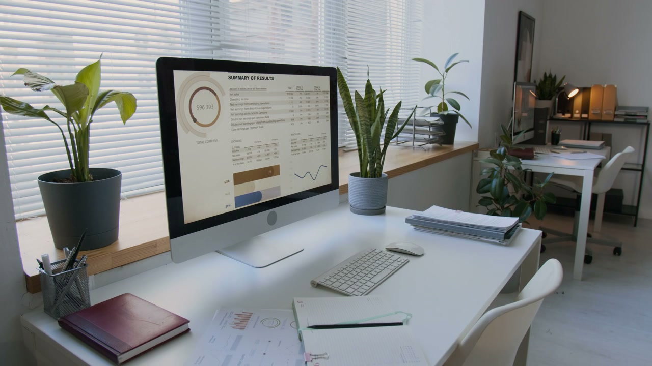 Modern Office Desk with Computer and Finance Data