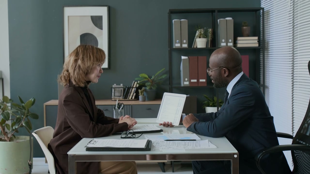Business People Discussing with Tablet in Office