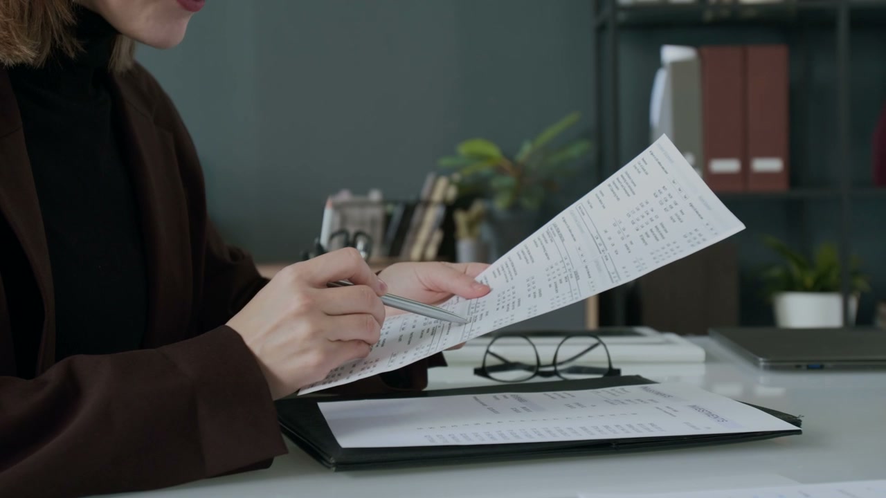 Businesspeople Exchanging Financial Documents