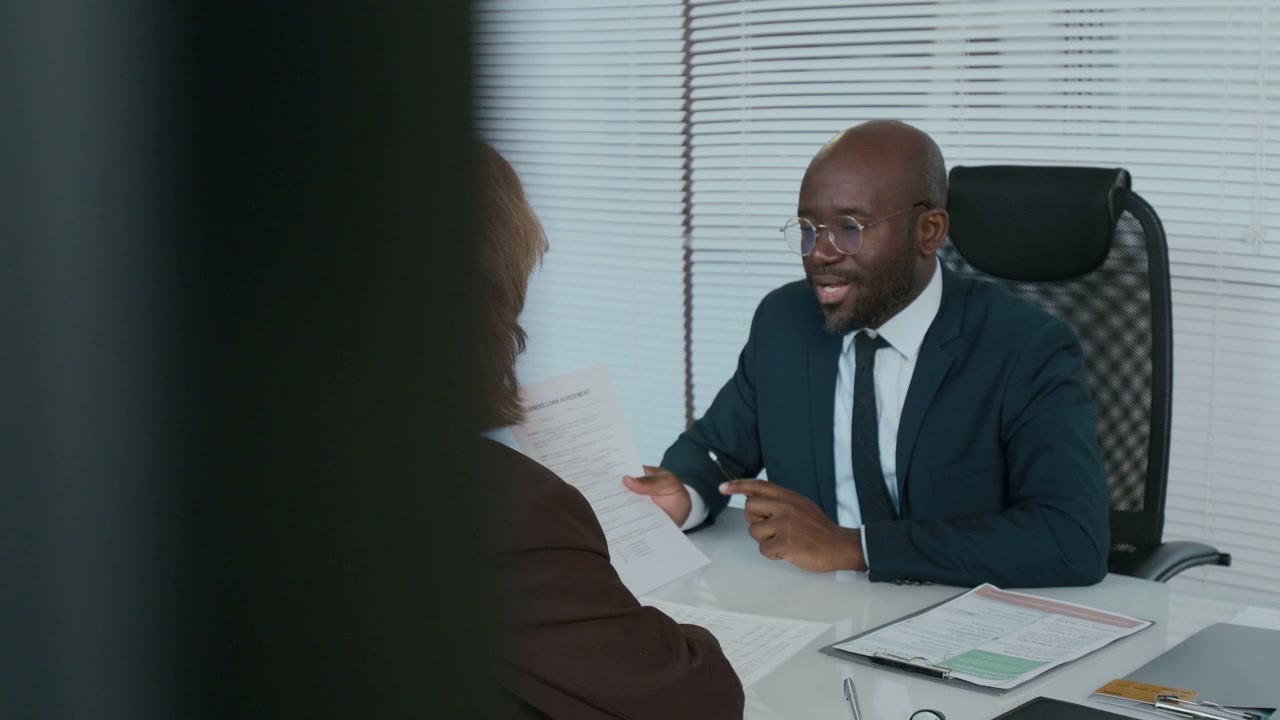 Financial Advisor Discussing Documents with Client