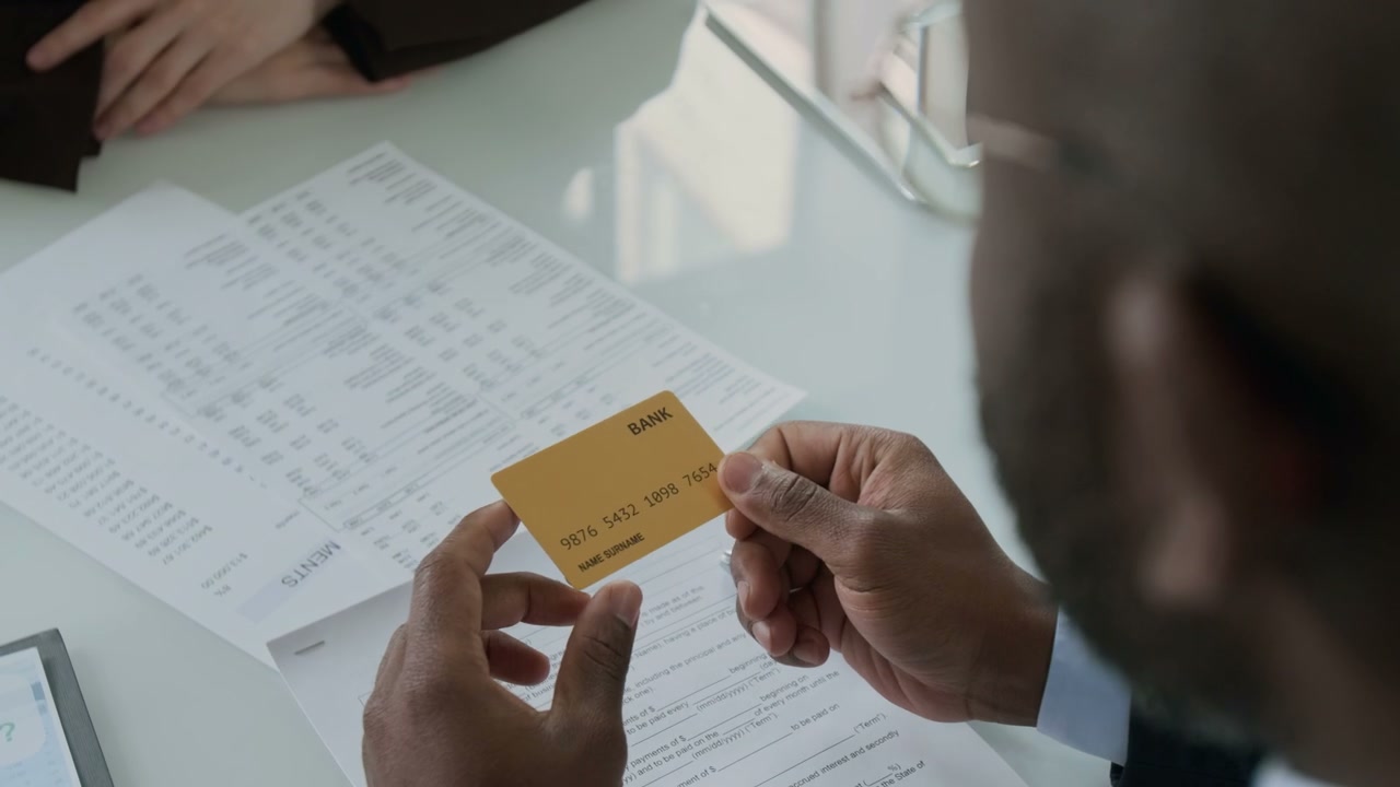 Client Handing Bank Card to Advisor