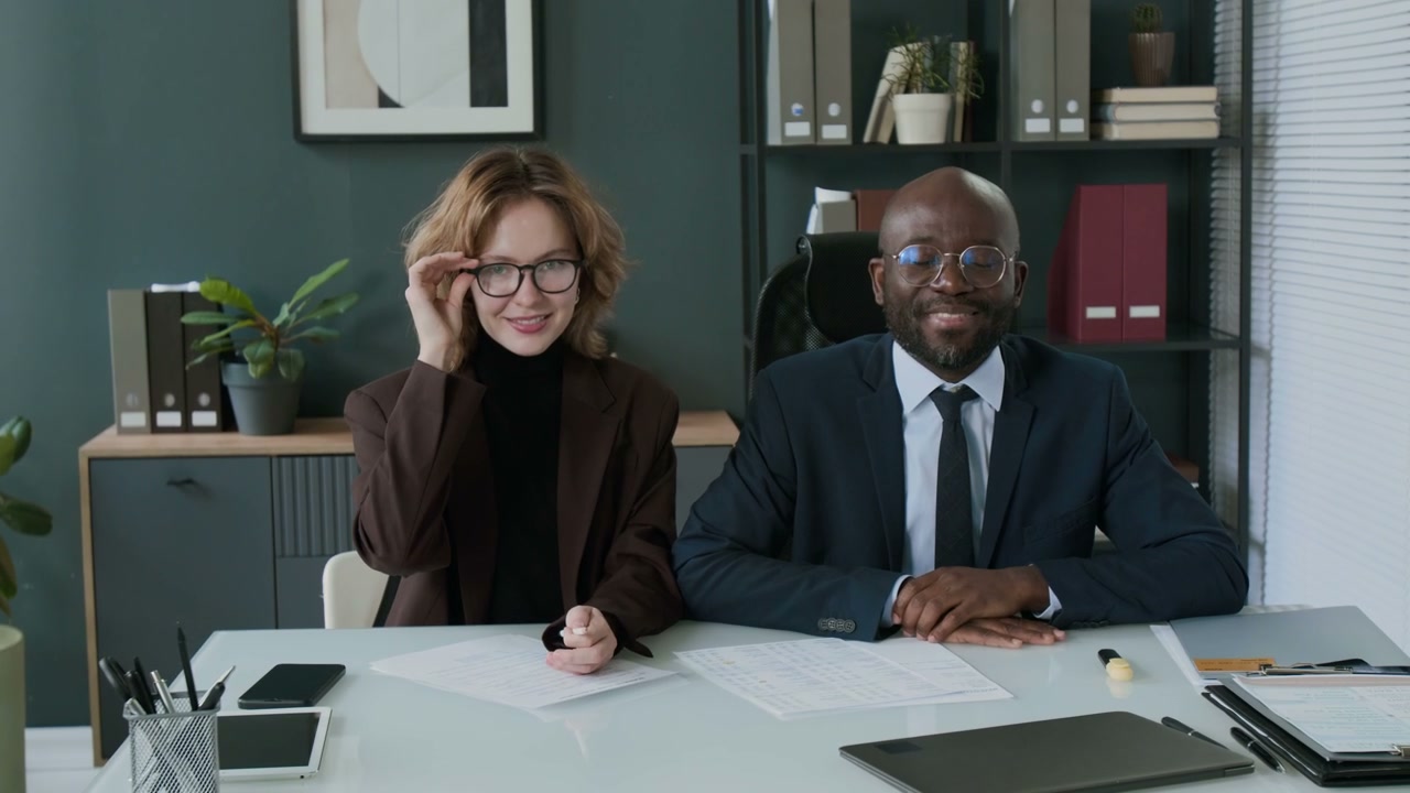 Diverse Business Duo Smiling in Office