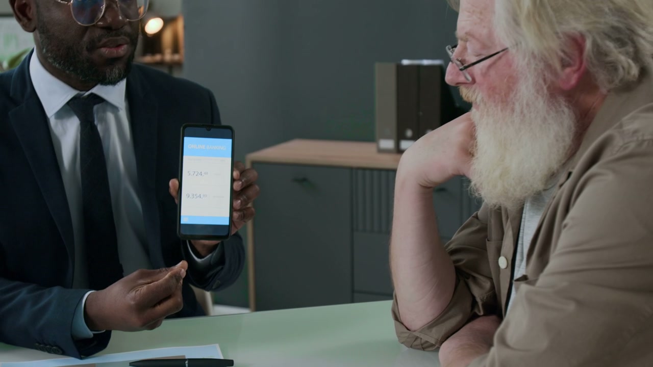 Financial Advisor Showing Banking App to Couple