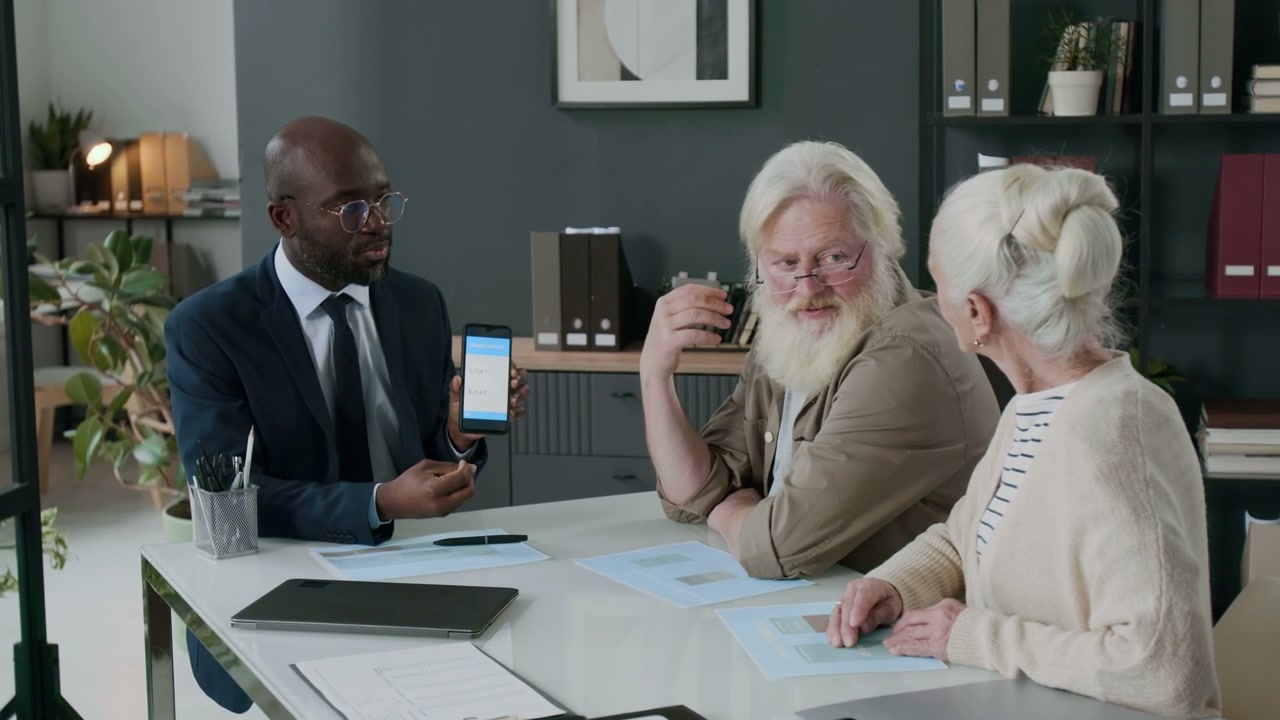 Financial Advisor Explaining App to Elderly Clients