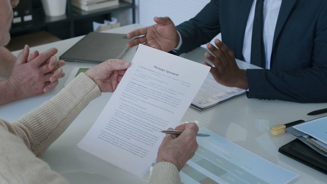 Senior Couple Reviewing Mortgage Agreement