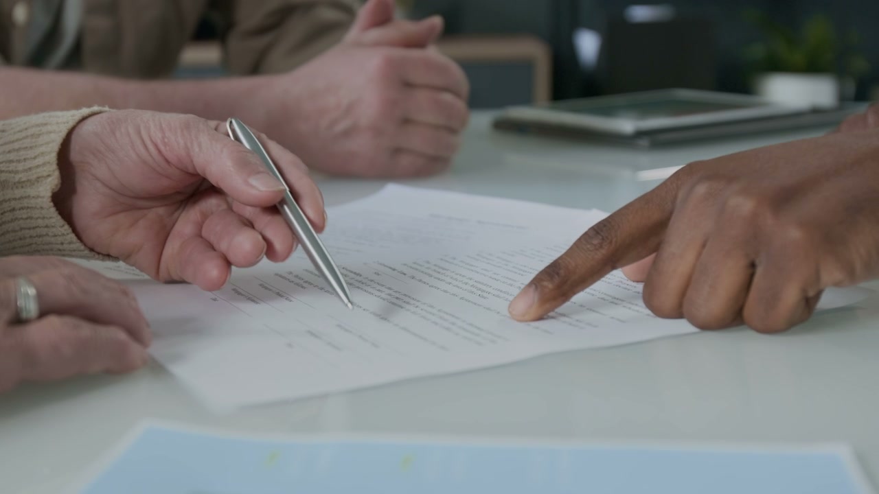 Hands Pointing at Business Contract Details