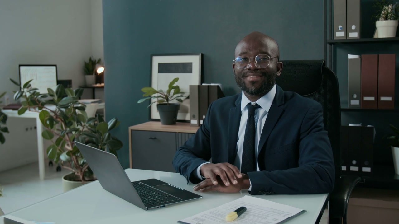 Smiling Black Businessman in Modern Office