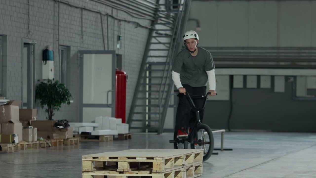 BMX Rider Performing Stunt in Hangar