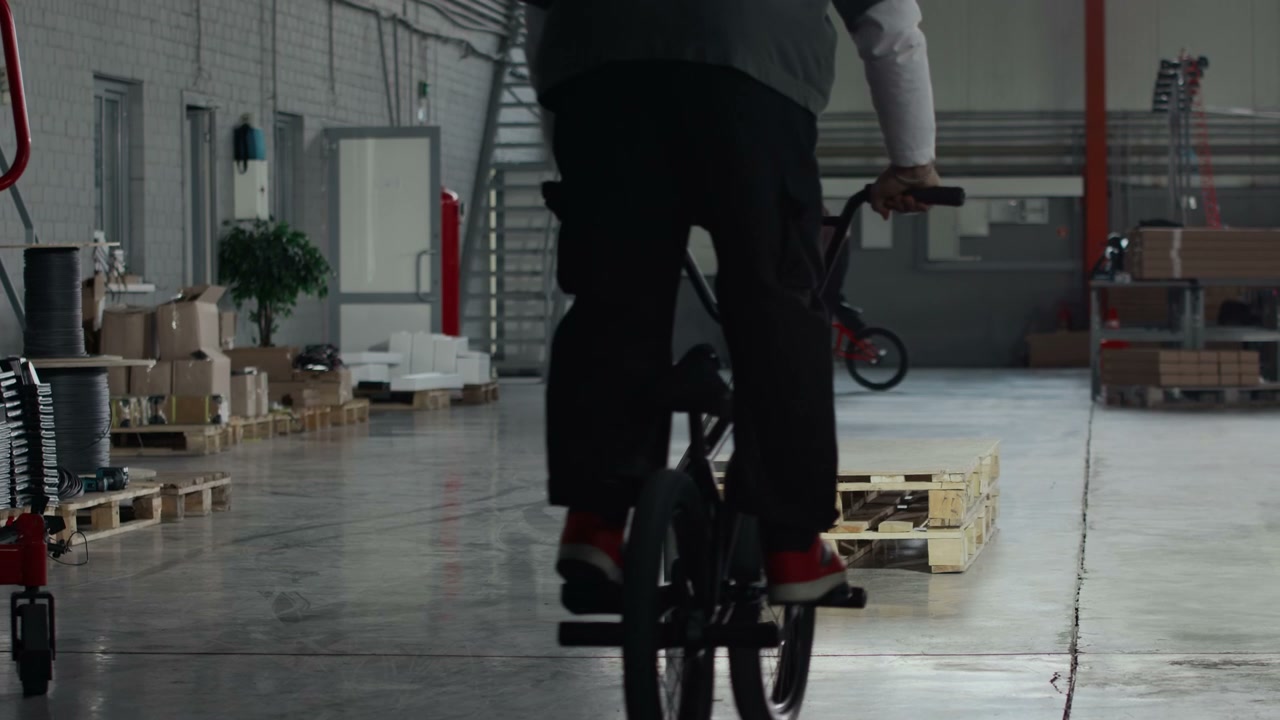 BMX Rider Doing Stunt On Rail In Hangar