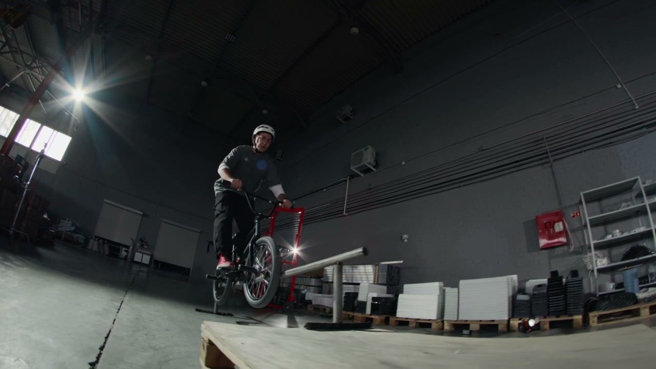 BMX Rider Jumps Rail, Manuals in Warehouse