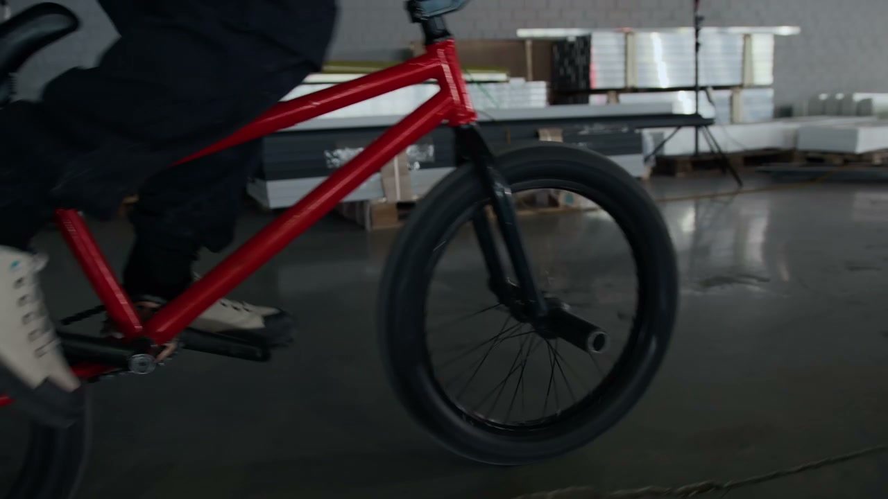 BMX Rider Performing Bunny Hop in Hangar