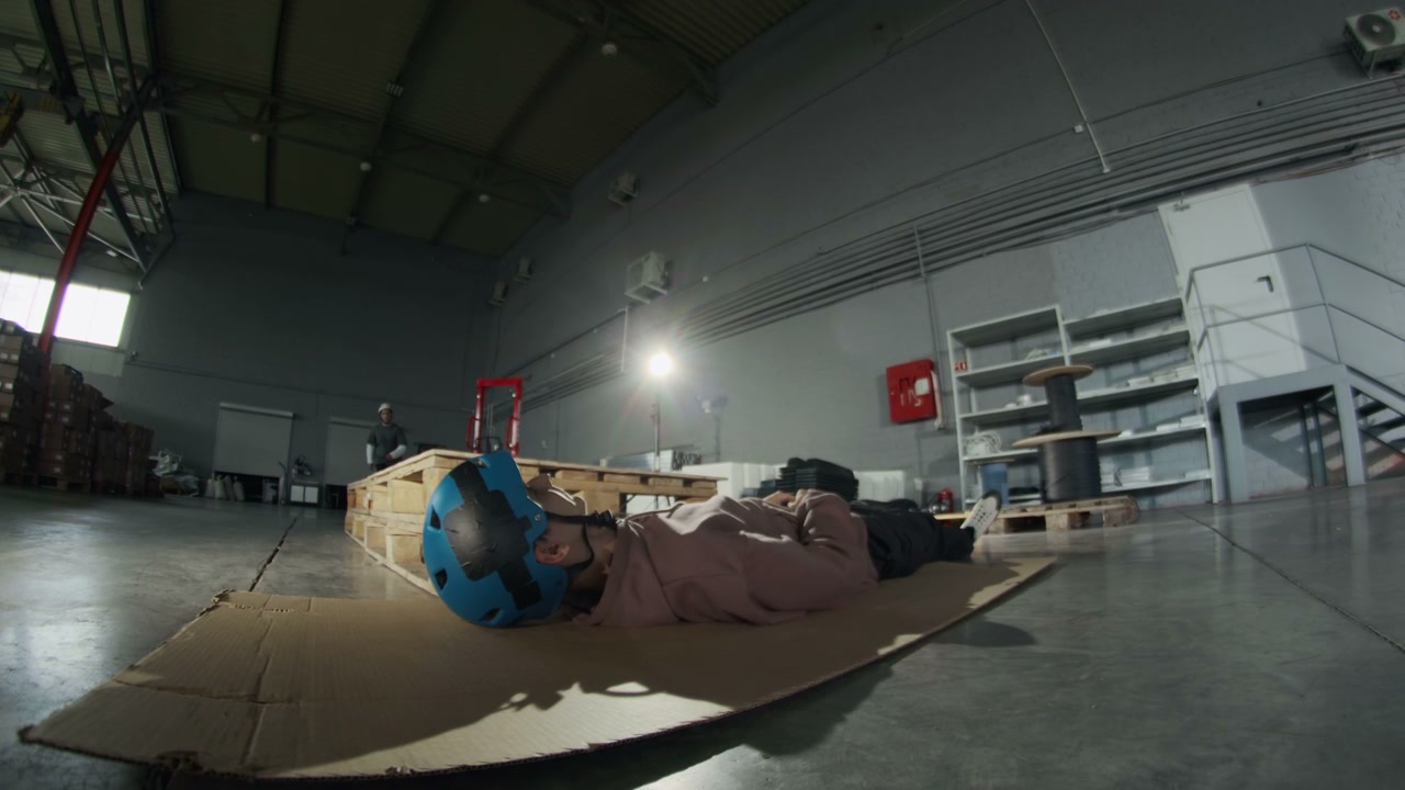 Inline Skater Jumps Over Person in Hangar