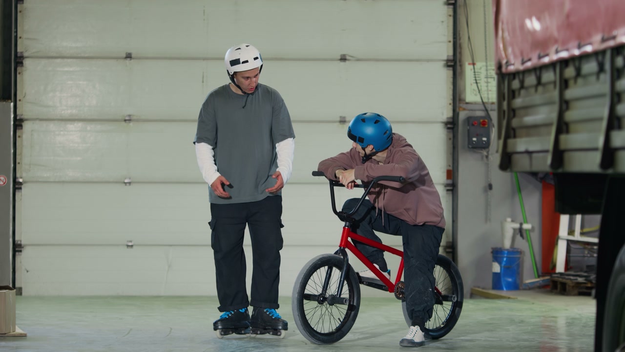 Young Men with BMX and Rollerblades in Hangar