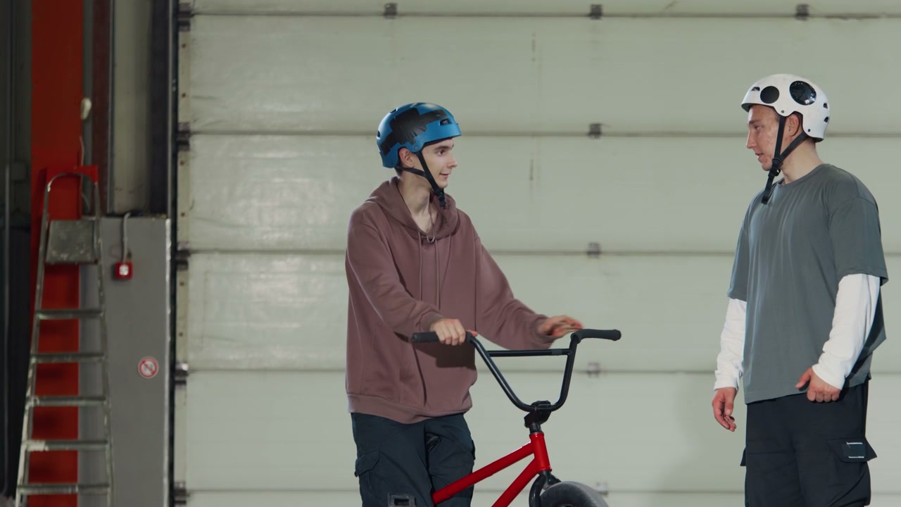 Young BMX Riders Posing in Hangar