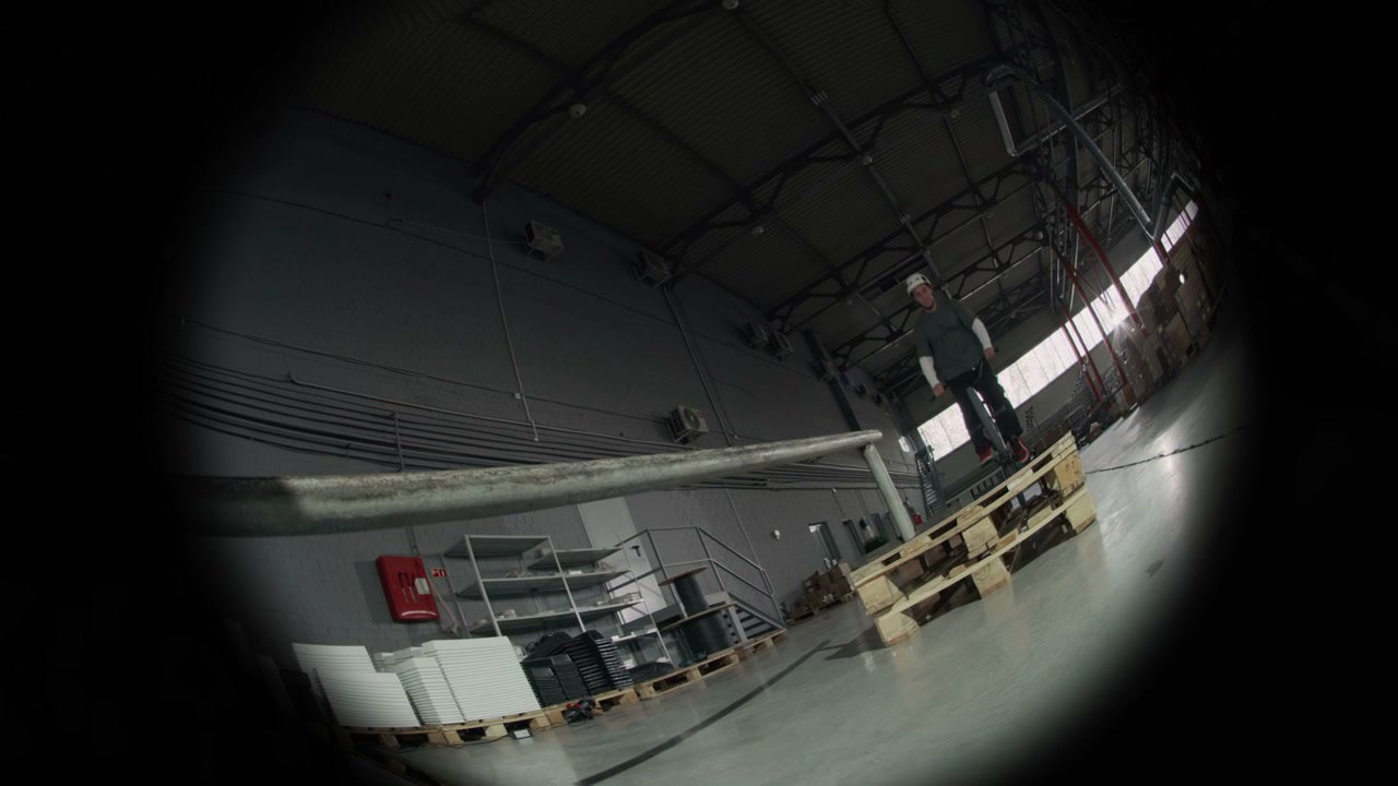 BMX Rider Jumps Rail in Hangar with Fisheye