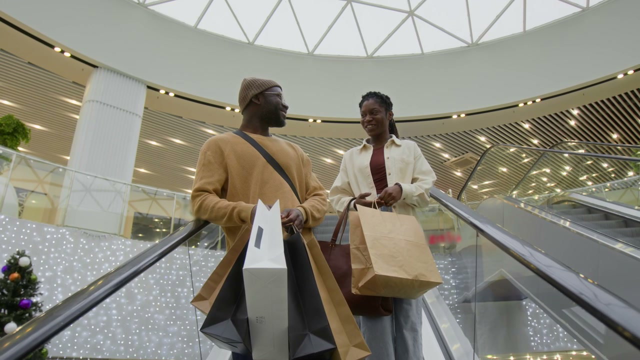 Smiling Couple Ascending Mall Escalator