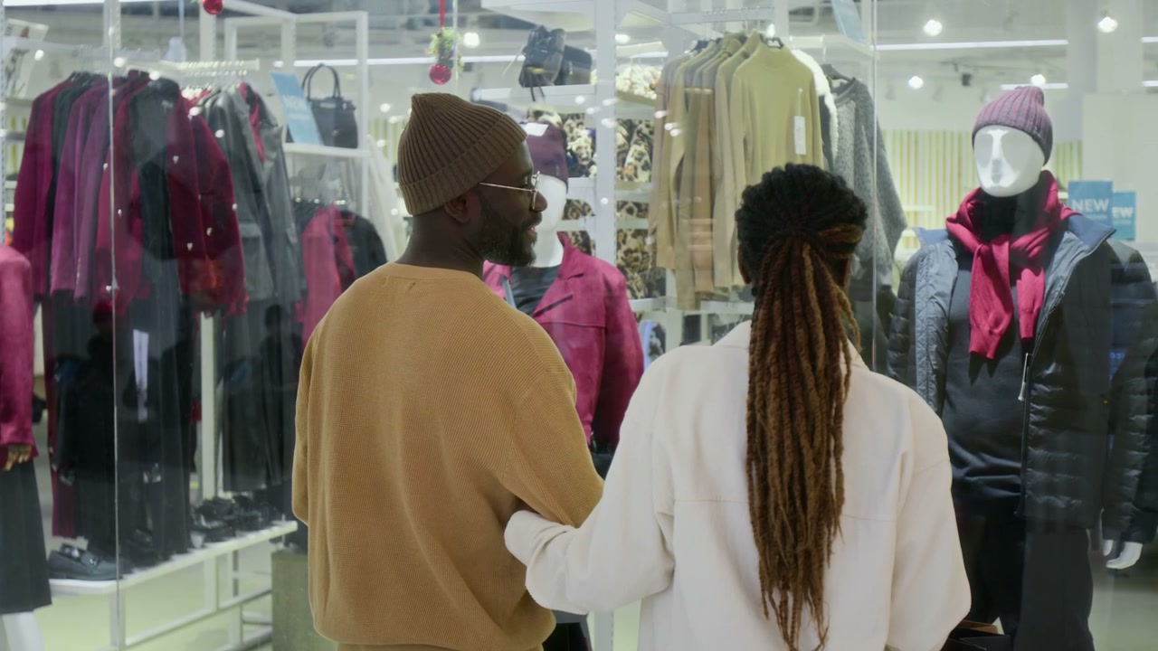 Couple Window Shopping at Clothing Store