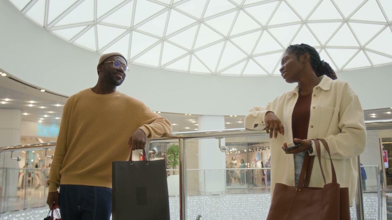 Happy Couple Chatting in Shopping Mall
