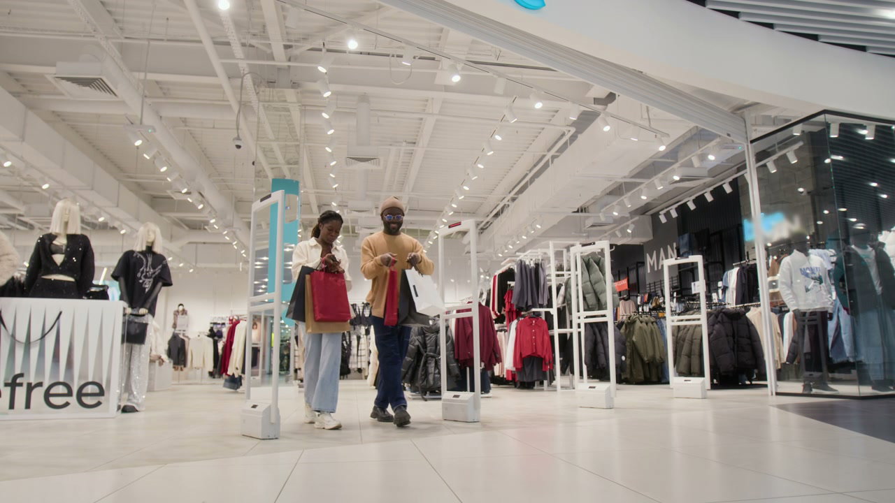 Happy Couple Leaving Clothing Store