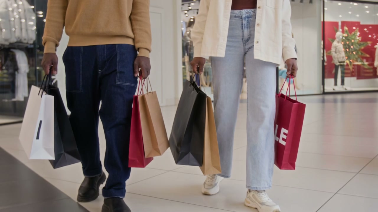 Couple Walking with Shopping Bags in Mall