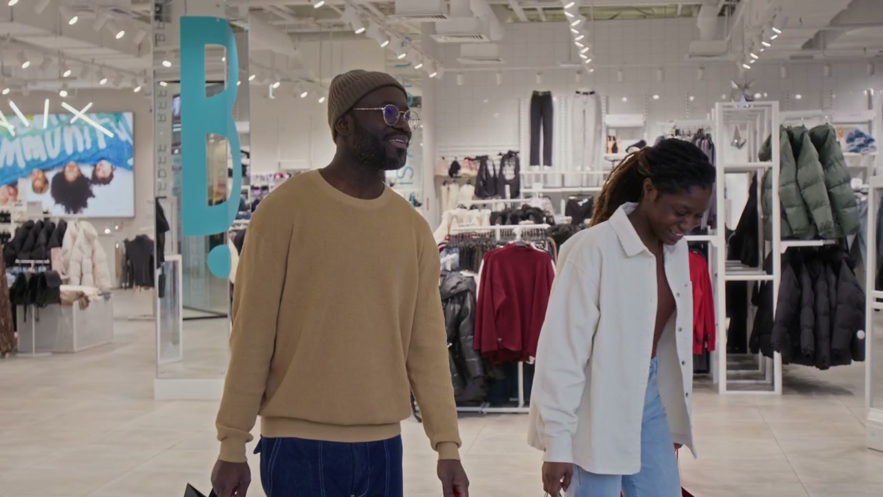 Happy Couple Exiting Clothing Store
