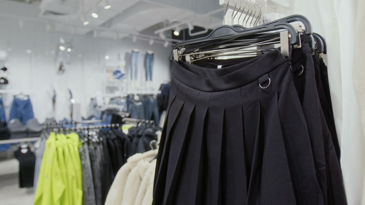 Black Pleated Skirt on Hanger in Clothing Store