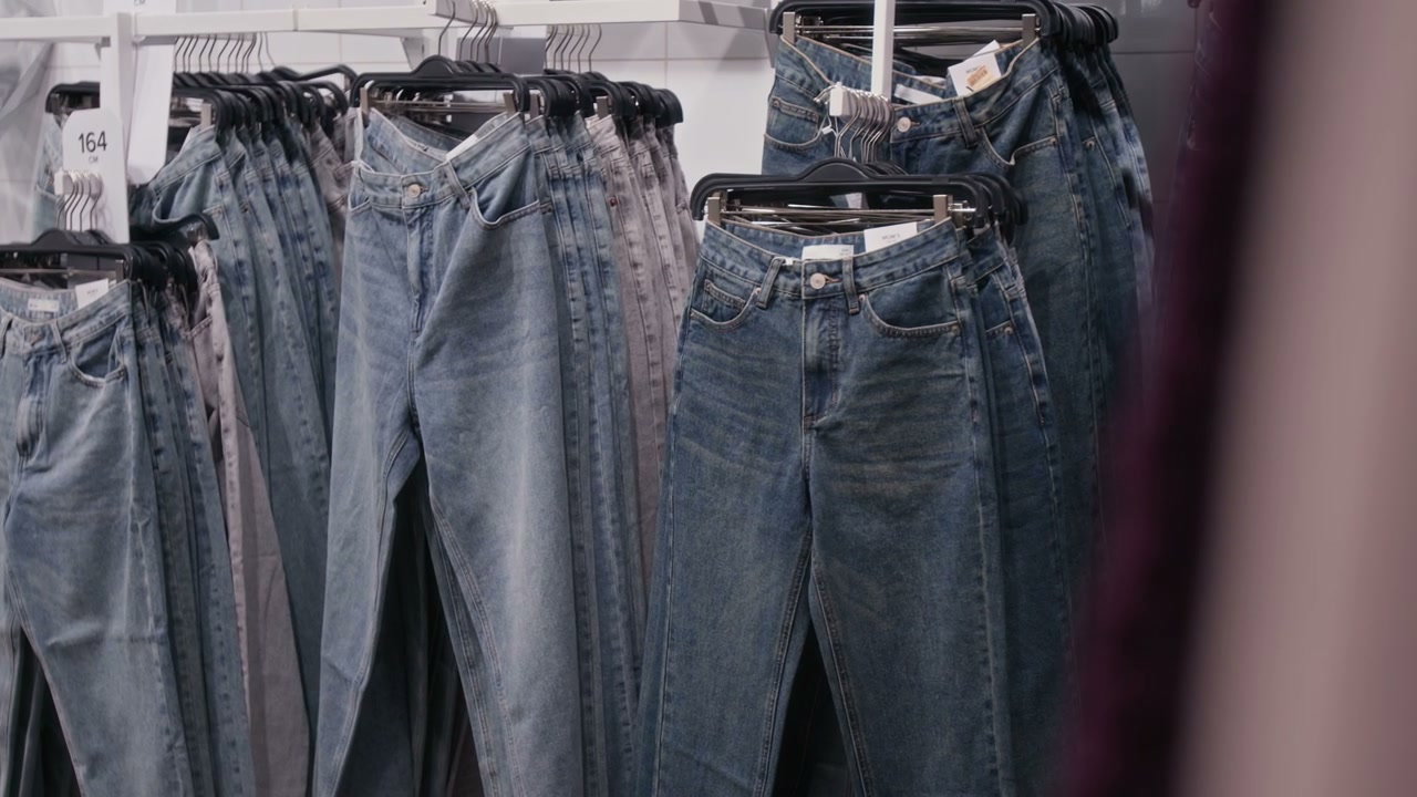 Blue Jeans Displayed on Racks in Retail Store