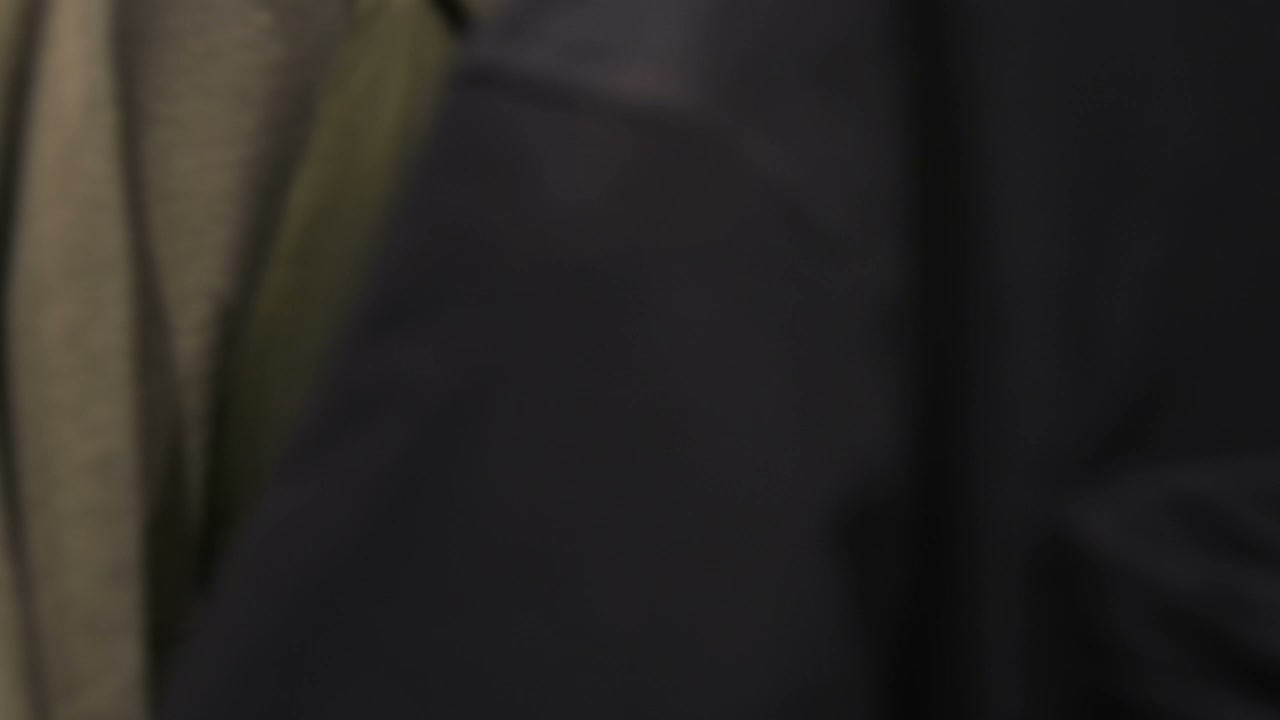 Man Browsing Clothes in Retail Store