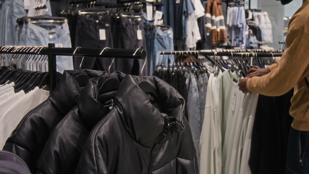 Customer Browsing Jackets in Clothing Store