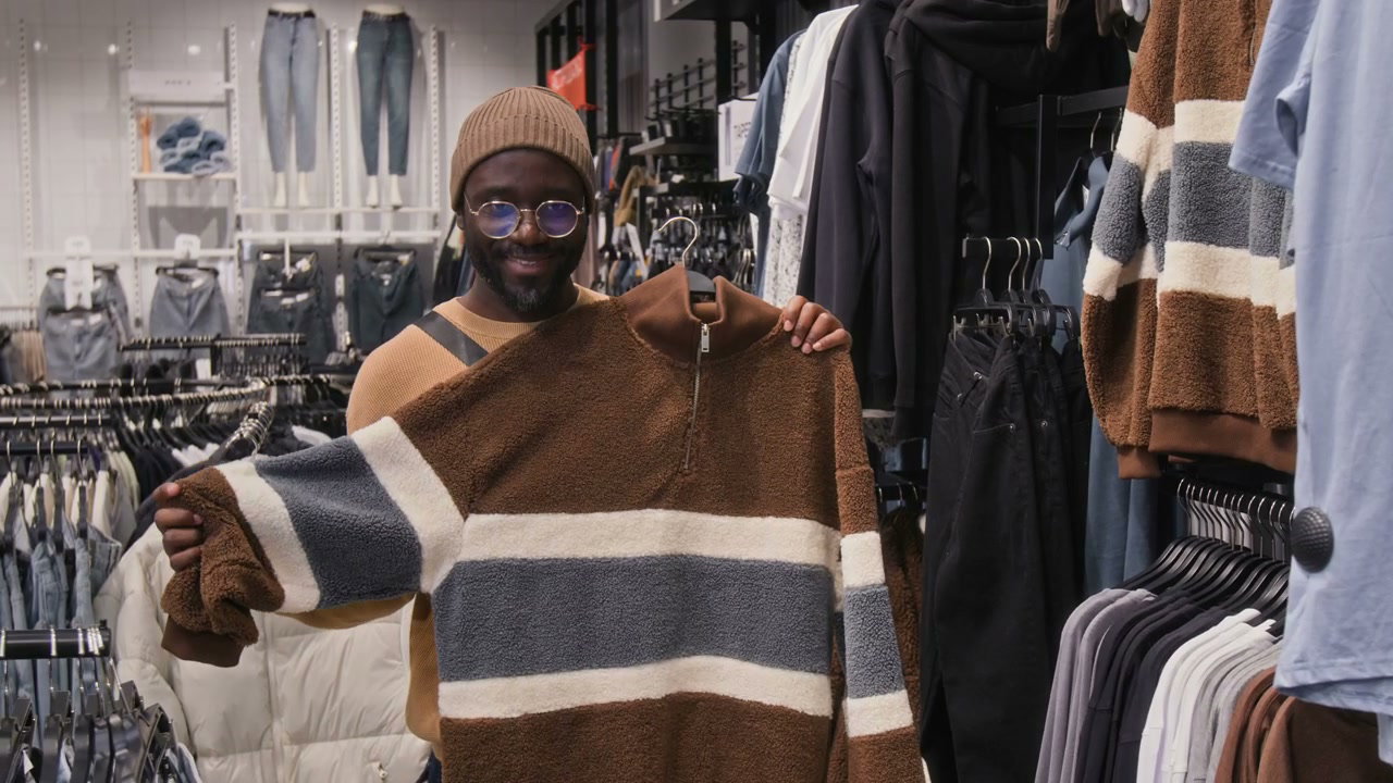 Smiling Man Shopping for a Sweater