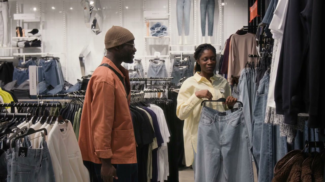 Couple Shopping for Jeans in a Clothing Store