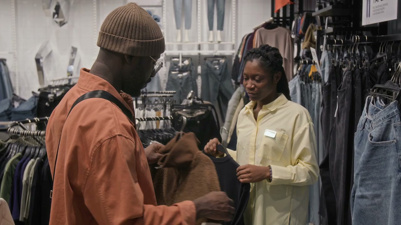 Man Shopping with Sales Assistant in Store