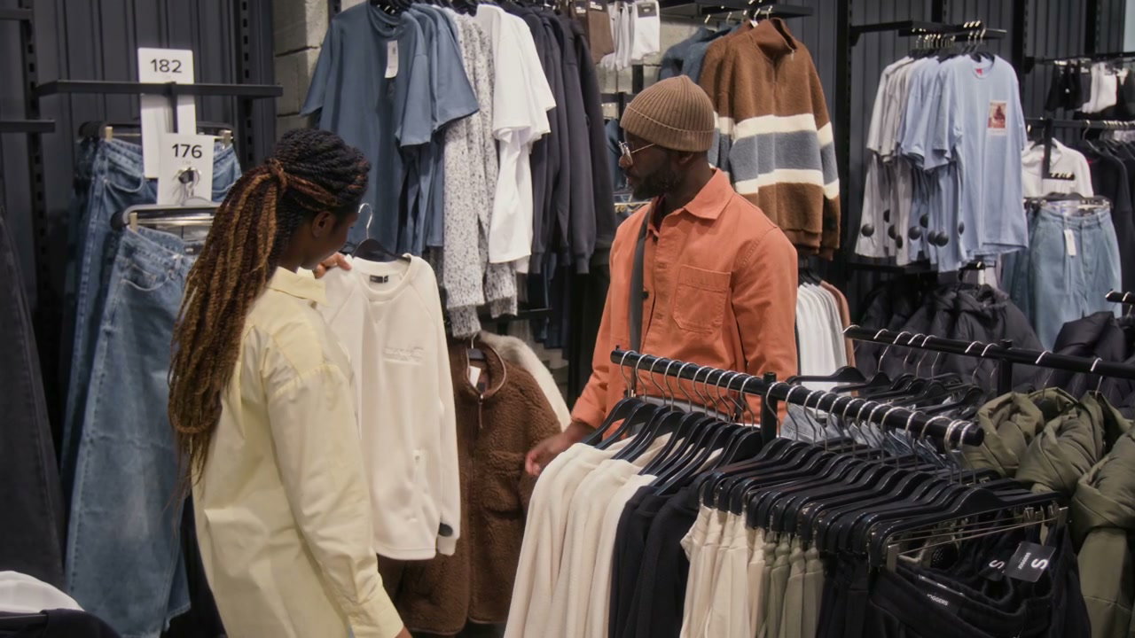 Couple Shopping for Apparel in Clothing Store
