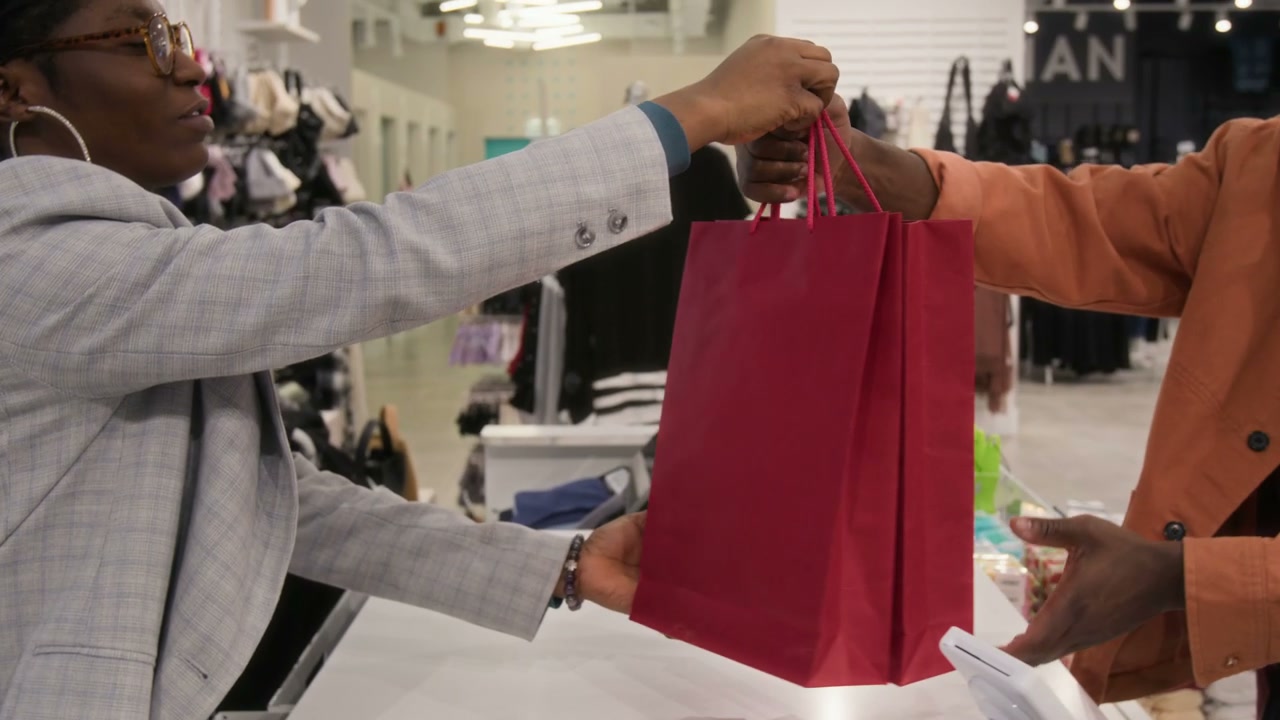 Sales Assistant Hands Shopping Bag