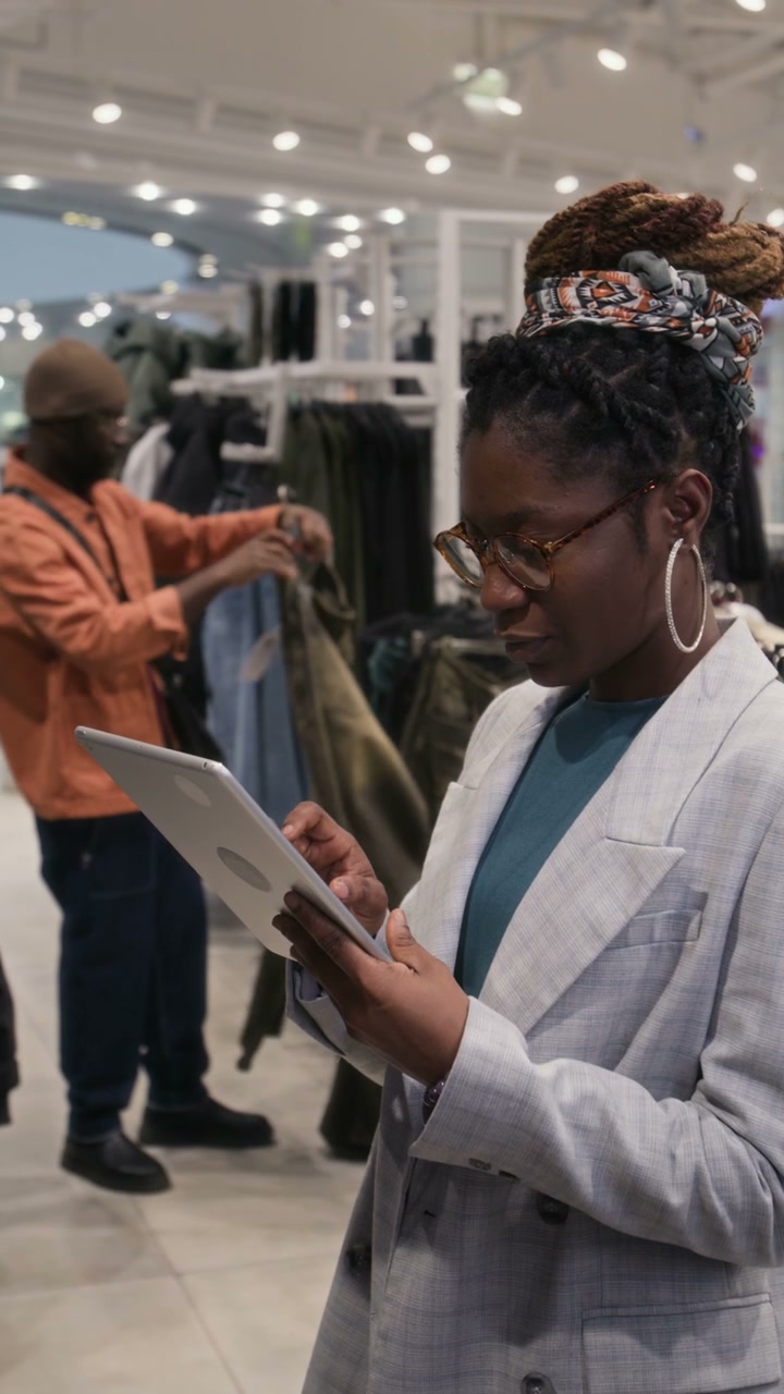 Professional Woman Using Tablet in Retail Store