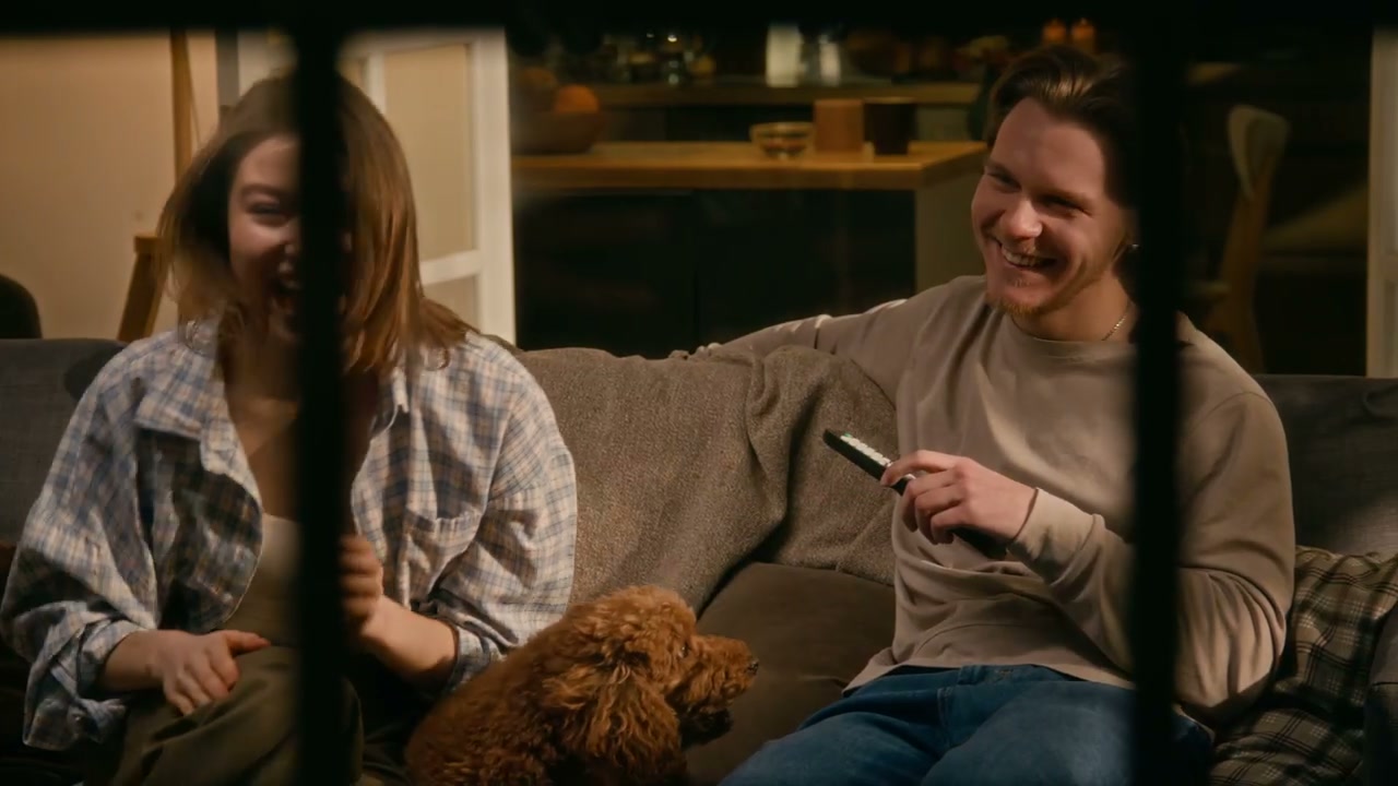 Couple and Dog Watching TV Through Window