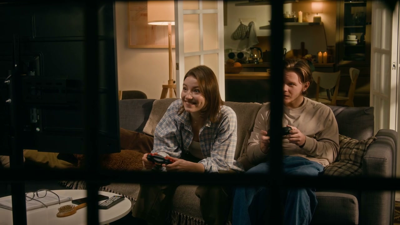 Couple Playing Video Games Through Window