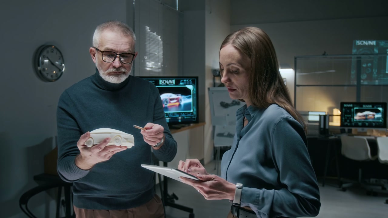 Automotive Designers Discuss Car Prototype