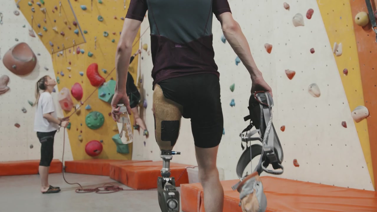 Amputee Climber Preparing at Indoor Wall