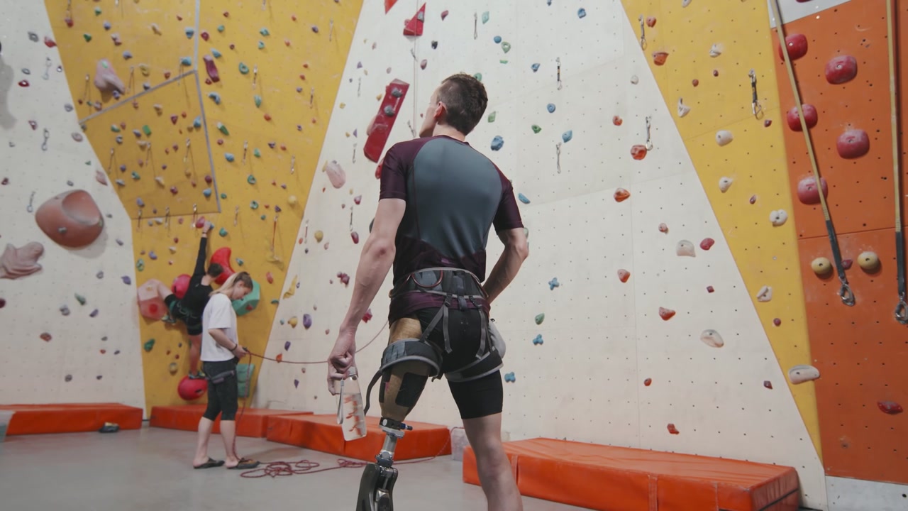 Man with Prosthetic Leg Prepares to Climb Wall