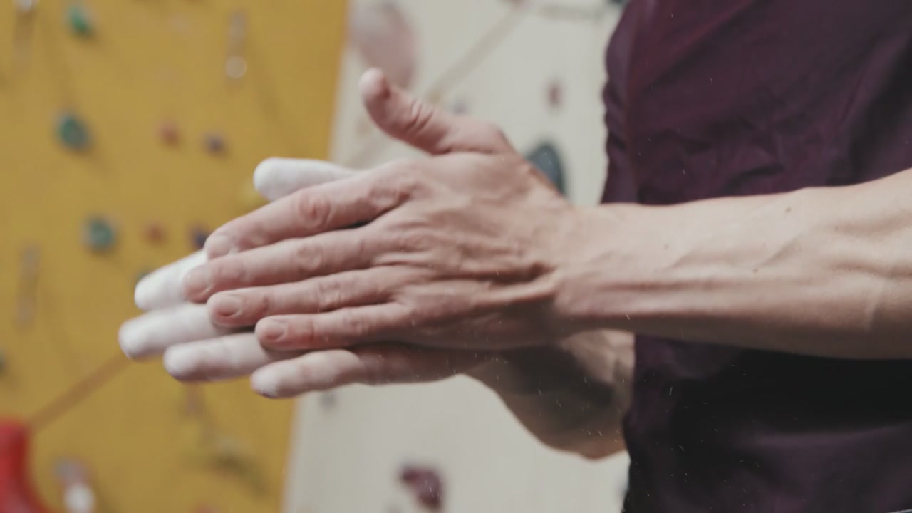 Climber Applying Chalk to Hands