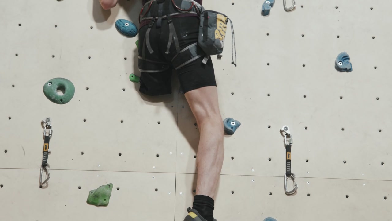 Man with Prosthetic Leg Climbing Indoor Wall