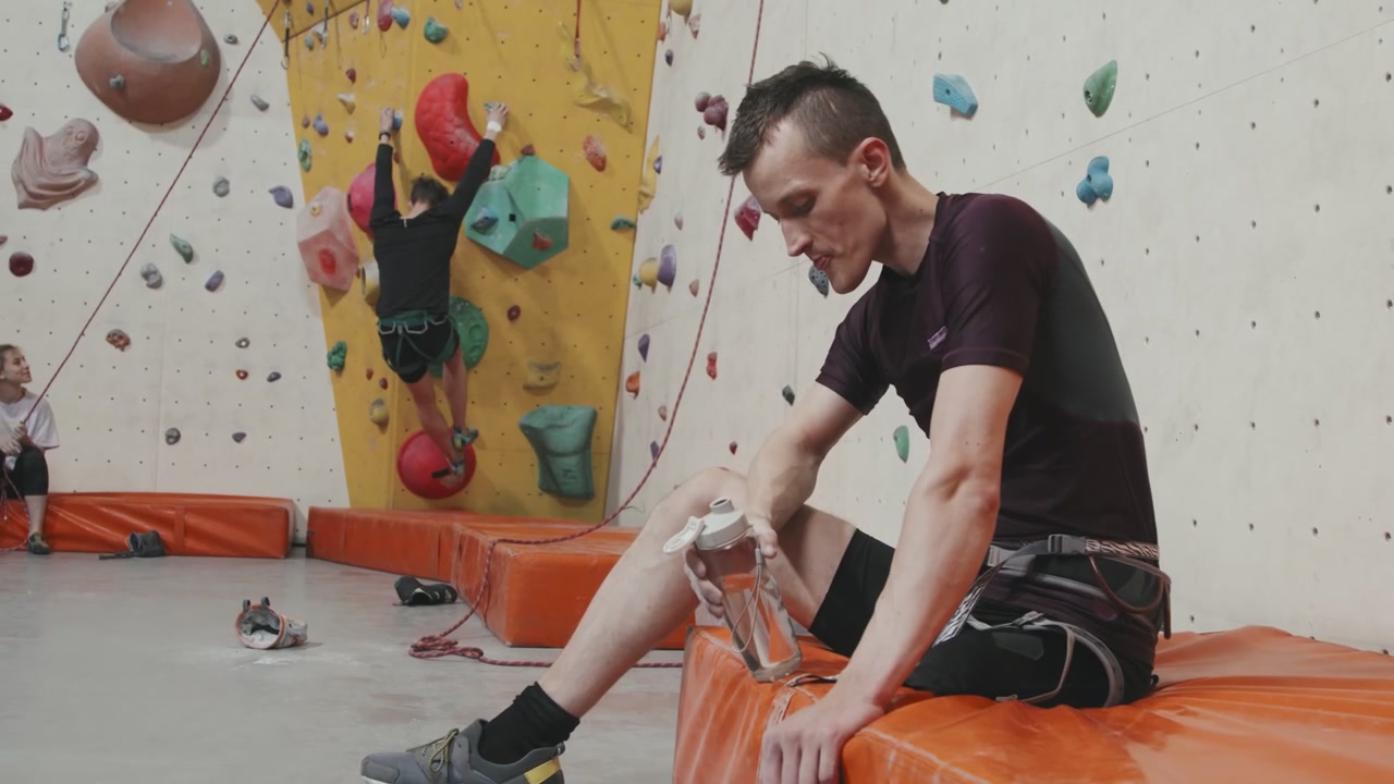 Man With Prosthetic Leg Resting In Climbing Gym