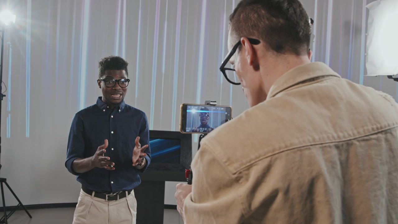 Cameraman Filming Presenter In Studio