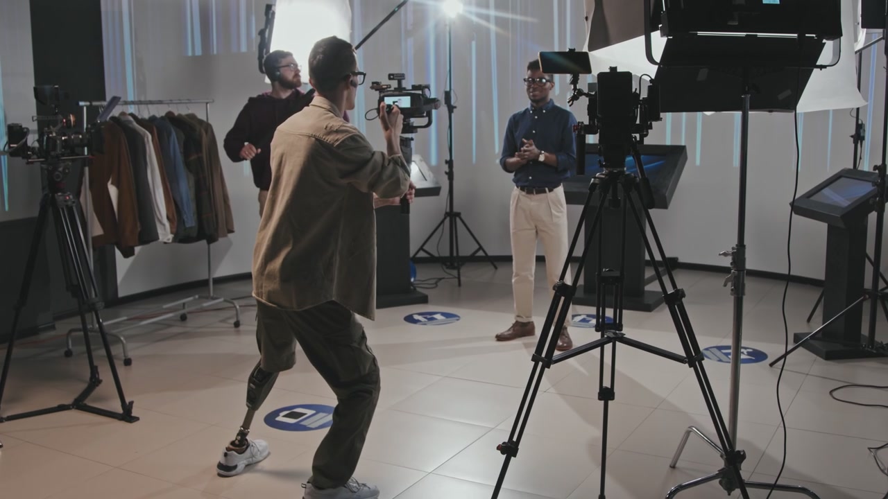 Cameraman with Prosthetic Leg Films Presenter