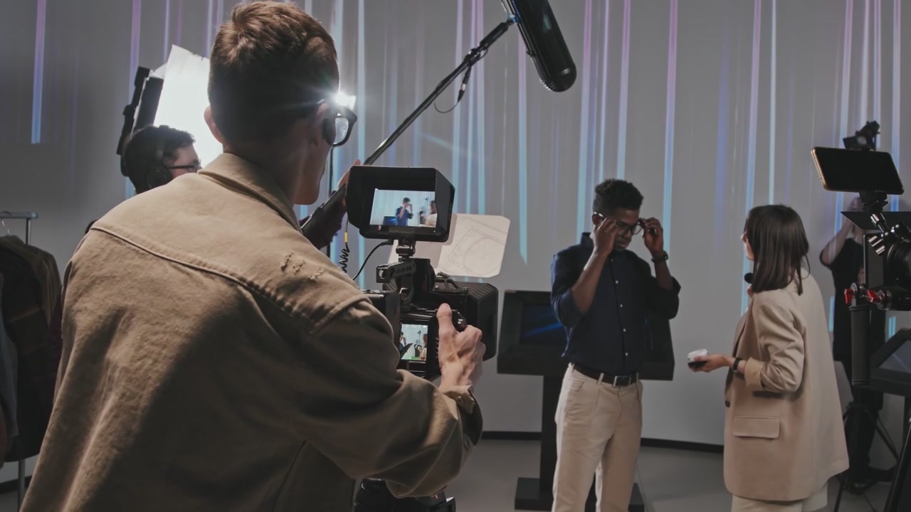 Cameraman Filming Talent on Studio Set