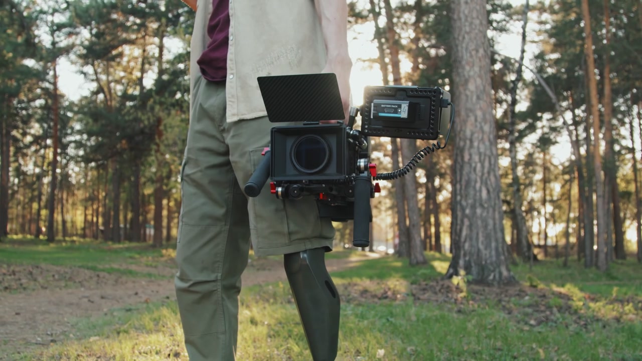 Filmmaker with Prosthetic Leg Holding Camera
