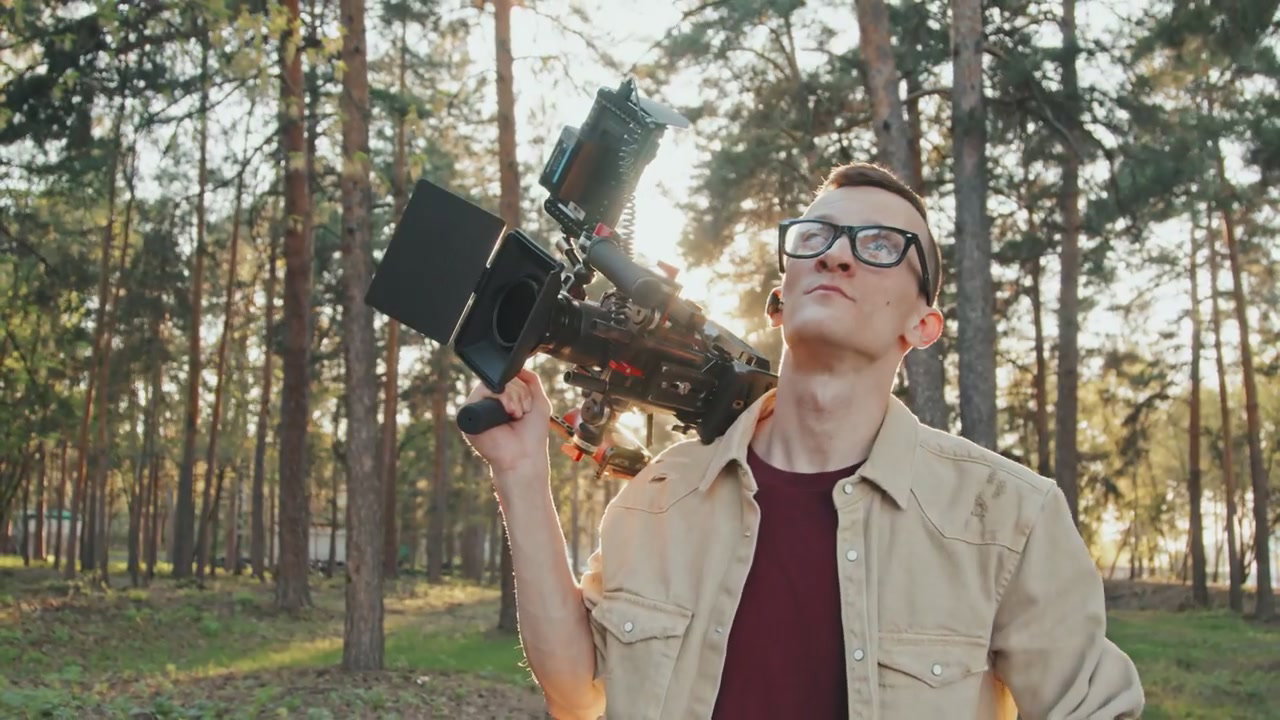 Cinematic Camera Operator in Forest Sunlight