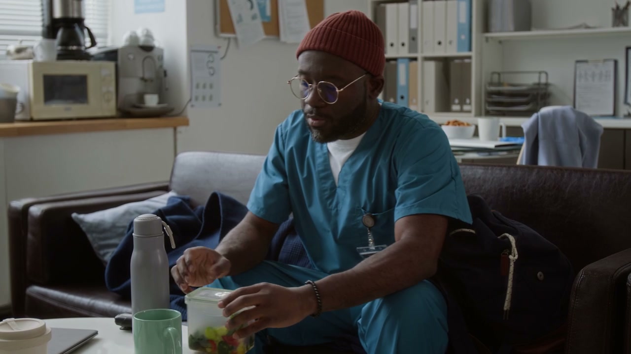 Doctor Taking Lunch Break in Office Lounge