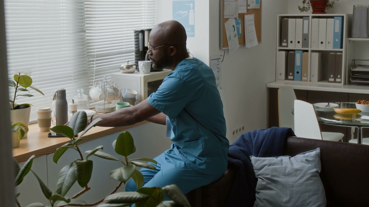 Healthcare Worker on Phone in Break Room